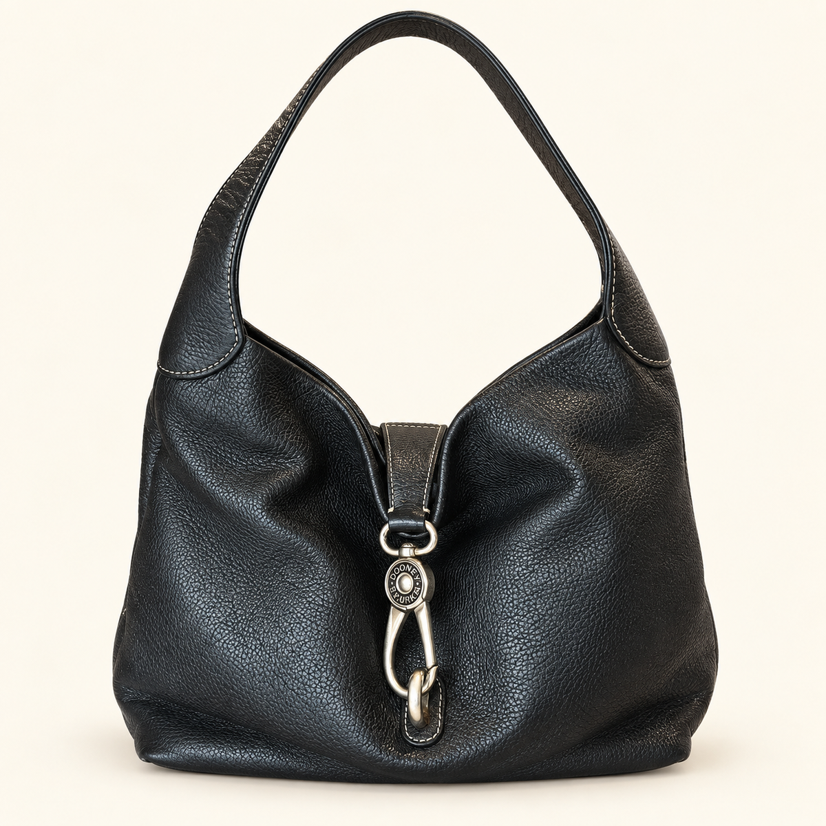 A black pebbled leather hobo shoulder bag with a silver-tone metal ring and D-ring closure on the front, set against a plain off-white background.