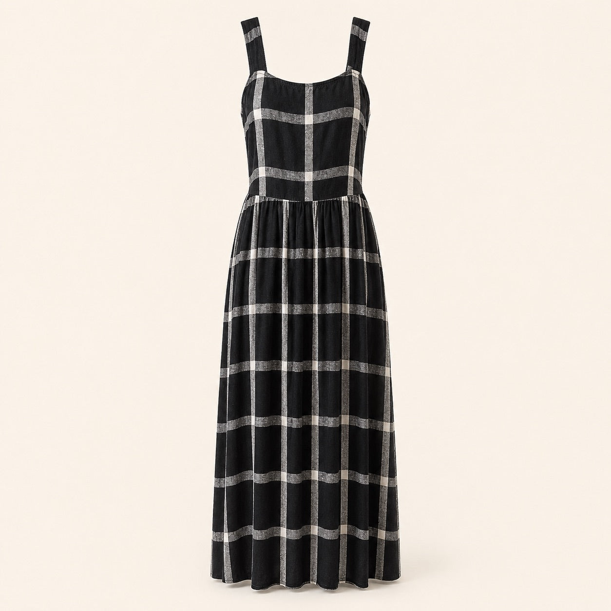 A sleeveless black midi dress with a silver metallic plaid pattern, featuring a structured bodice and wide shoulder straps, shown against a solid light beige background.