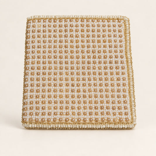 A square beaded clutch bag featuring a grid pattern of cream and gold faux pearls with a matching gold beaded border, set against a solid off-white background.