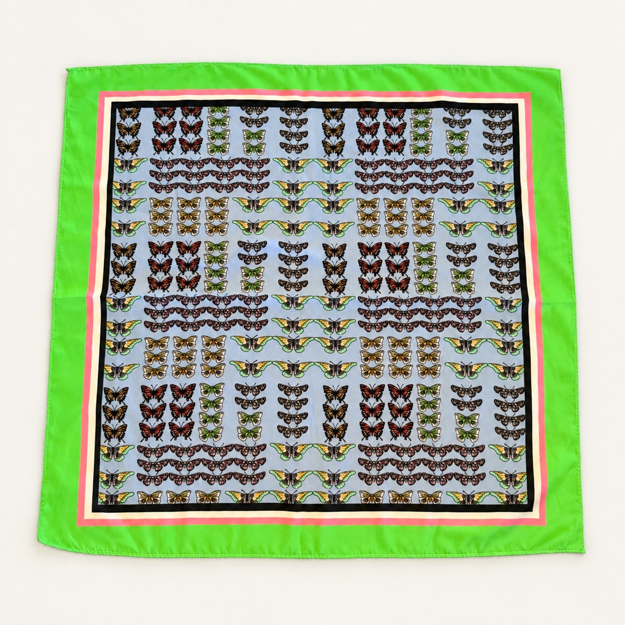 A square silk scarf featuring a light blue background filled with rows of detailed butterfly and wing patterns, framed by a vibrant lime green border, a pink inner border, and a thin black outer border.