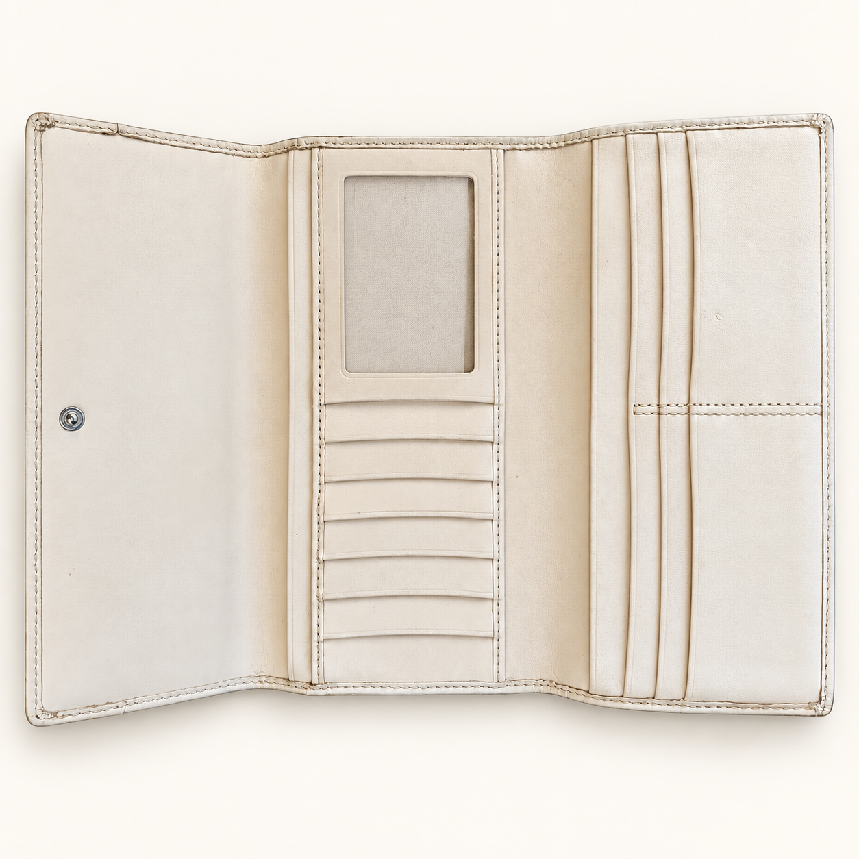 An open cream-colored leather wallet with multiple card slots, a central ID window, and a snap button closure, shown against a solid off-white background.