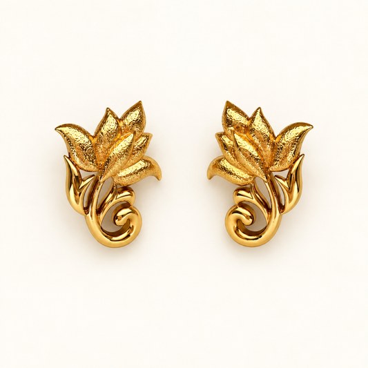 A pair of gold-toned floral stud earrings with textured leaf and petal details, shown on a clean off-white background.