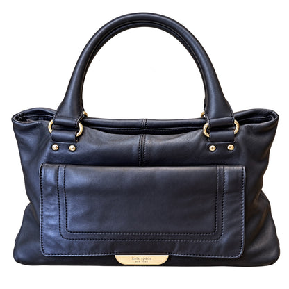A black leather handbag with double top handles, gold-tone hardware, and a front slip pocket, shown against a plain white background.