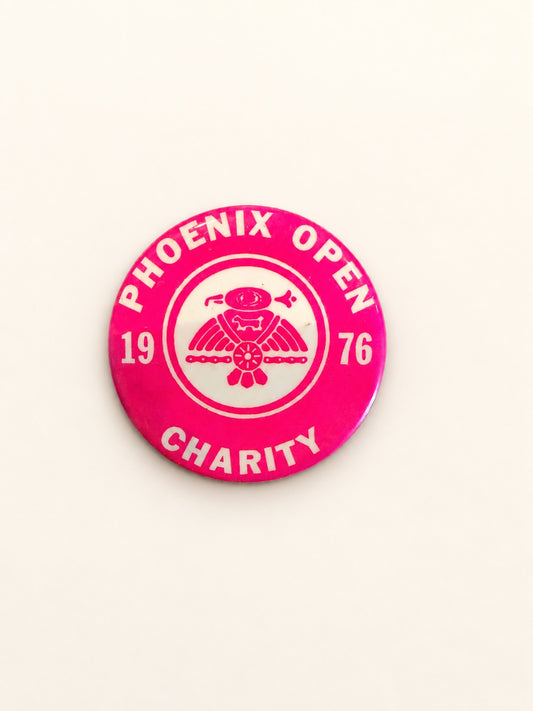 A round pink and white Phoenix Open Charity 1976 pinback button badge, displayed on a clean off-white background.