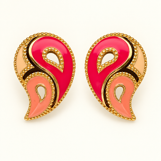 A pair of ornate paisley-shaped earrings with vibrant pink, coral pink, and peach enamel sections outlined in gold-tone metal with beaded borders, set against a plain white background.